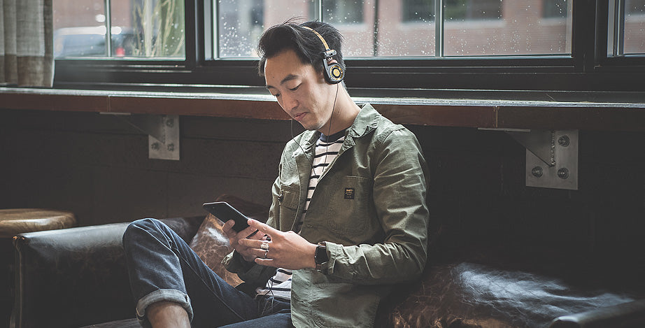 Drew Westphal sitting on a couch wearing Koss Porta Pros.