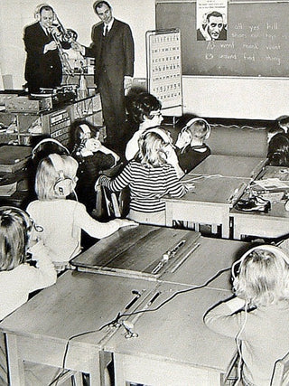 John C Koss in a classroom with kids