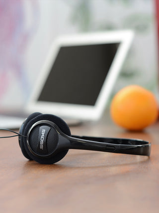Koss KPH7iK On Ear Headphones on a desk with a tablet