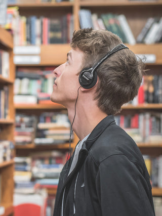 Man at a library wearing Koss KPH7iK On Ear Headphone