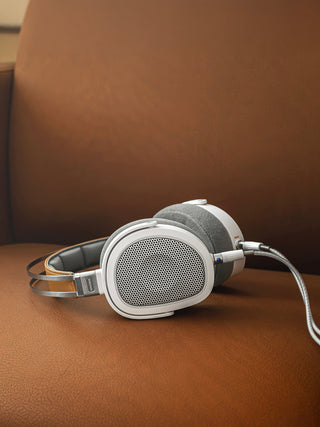 Headphones on a brown leather surface