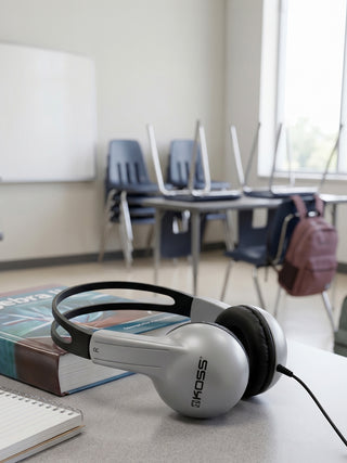 Koss headphones on a desk in a classroom setting