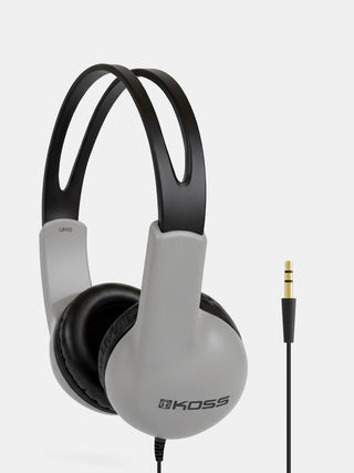 Koss UN10 over-ear wired headphones in gray and black, shown with a gold-plated 3.5mm audio jack on a light gray background.