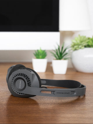 Koss KPH30 Wireless Headphones in Gray laying on a desk with built-in audio controls visible