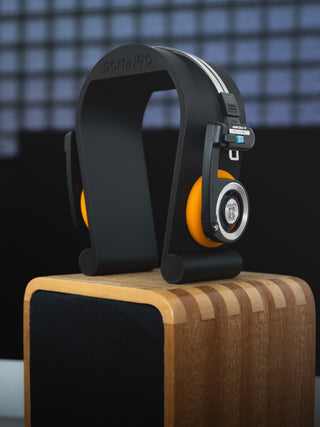 Black wireless Porta Pro's placed on new 3D printed Koss Porta Pro stand on top of desk speaker.