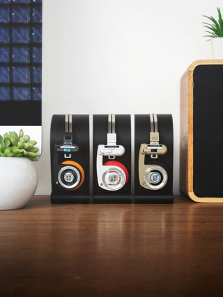 Black, Artic White & Beige Rythm Wireless Porta Pro's resting on new 3D printed Koss Porta Pro stand next to eachother on desk.