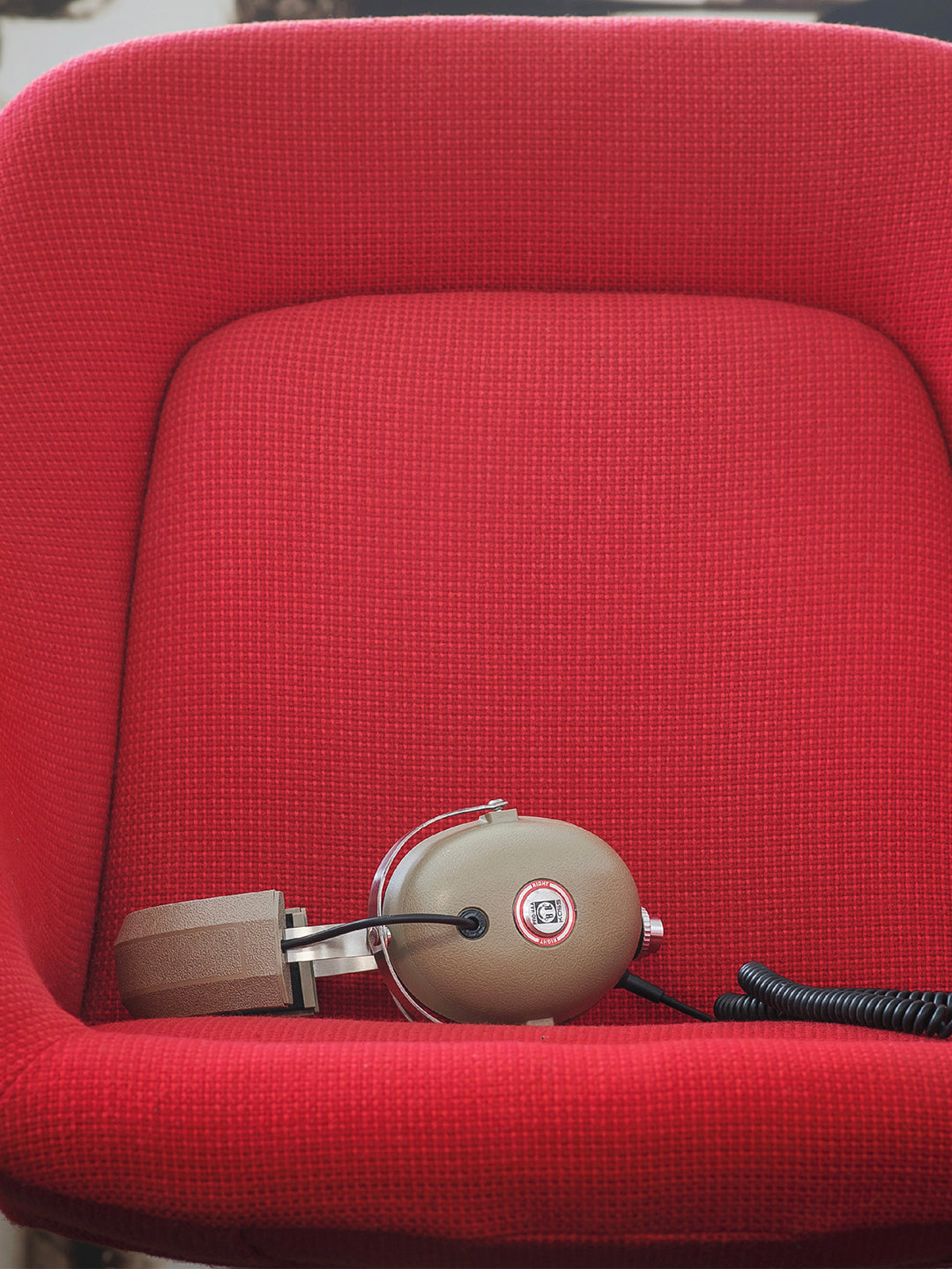 Koss Pro4aa on red vintage tweed chair 