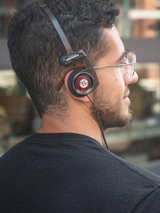 Man wearing black headphones with a blurred background