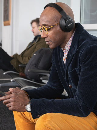 Man waiting at a station wearing Koss BT740i QZ Wireless Headphones