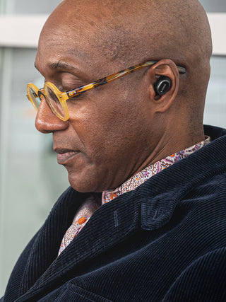 Man at airport wearing Koss TWS250i True Wireless Ear Buds