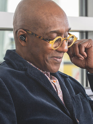 Man with glasses wearing Koss TWS250i Ear Buds